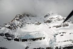 24 Mount Assiniboine With Summit In Clouds From Helicopter In Winter.jpg
